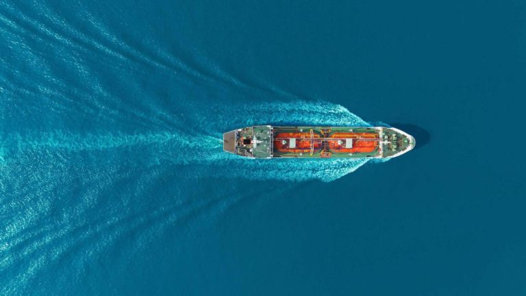 A cargo ship sailing at sea as seen from above