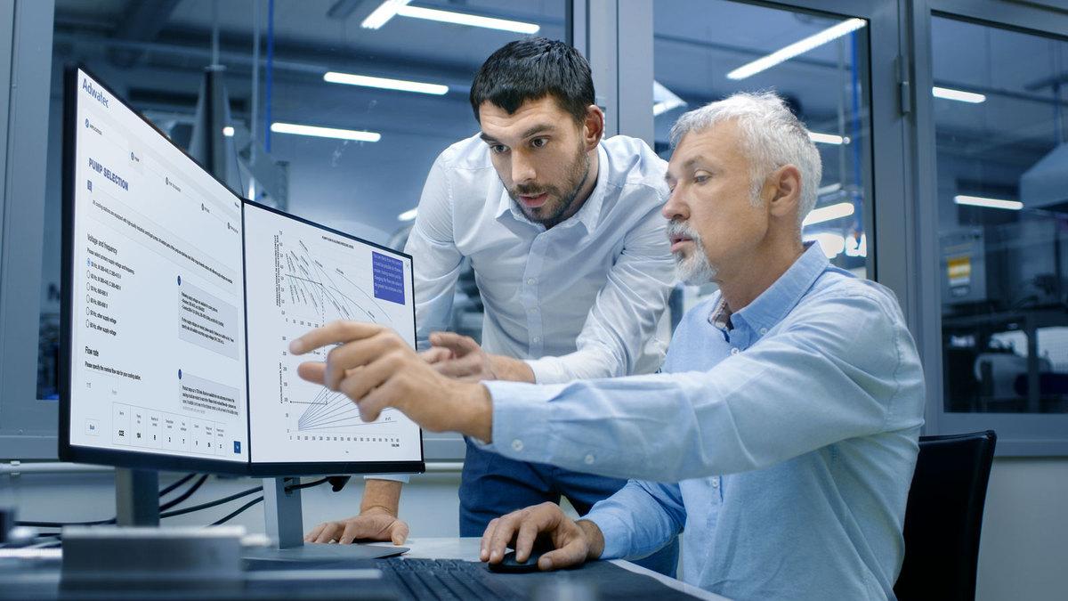 Two designers by computer screens