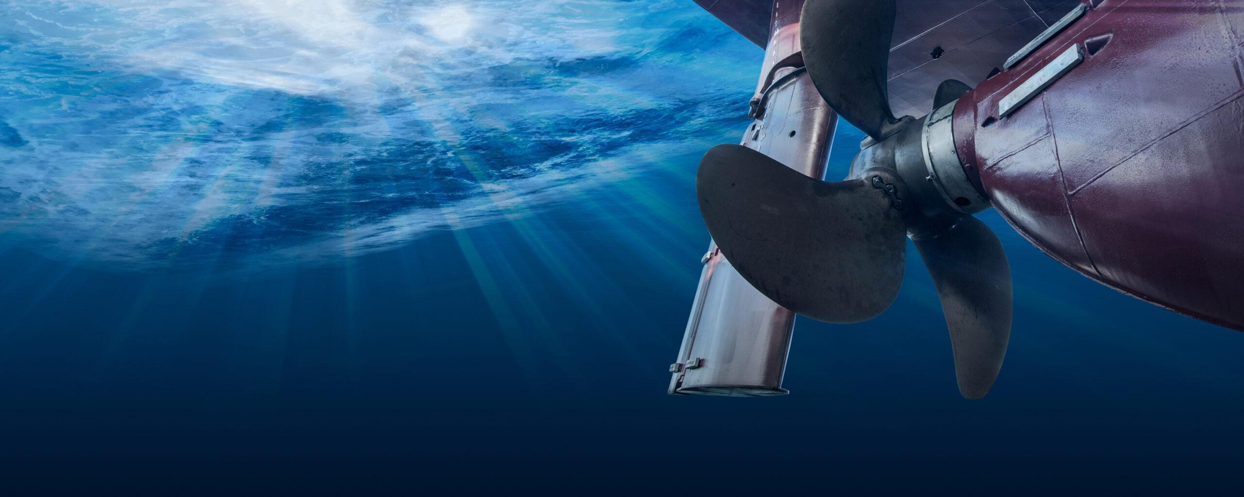 Propeller and rudder of big ship underway view from underwater. Close up image detail of ship.