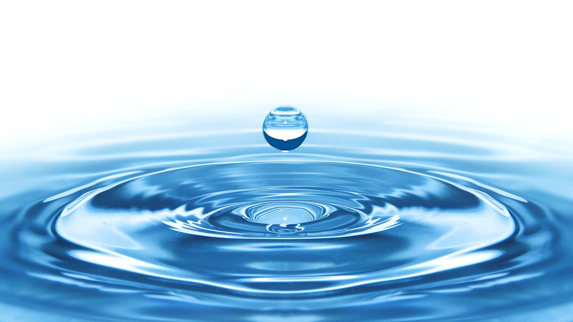 A drop of water falling on the surface of the water